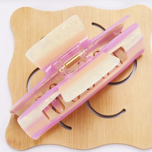 Close-up of a 14cm gradient pastel hair claw clip with strong gold metal spring