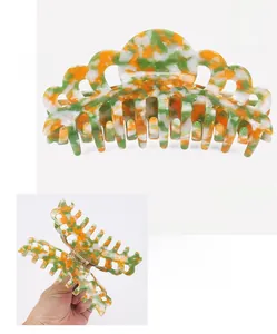 Detailed view of a 14cm acetate hair claw clip with floral pattern and specifications