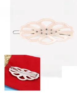 Detail view of acetate leaf hair clip with rhinestones and pearl showing dimensions 3x6.6cm