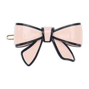 Close-up of pink acetate bow hair clip with black edges and metallic flat clamp