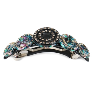 Detailed view of acetate spring hair clip with sparkling rhinestones and colorful rings
