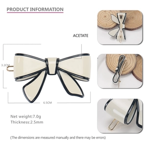 Classic cream acetate bow hair clip with black trim and dimensions for hairstyling