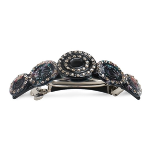 Detailed close-up of acetate barrette with sparkling rhinestones and metal spring clip