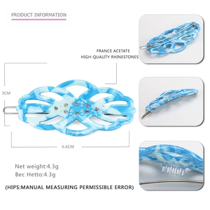 Detail of a blue marble acetate hair clip with rhinestones and 6.6cm dimensions