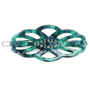 Detail shot of green marble acetate hair clip featuring hollow design and white rhinestones