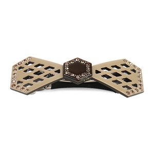 Detail view of khaki spring hair clip with brown hexagon and shimmering rhinestones