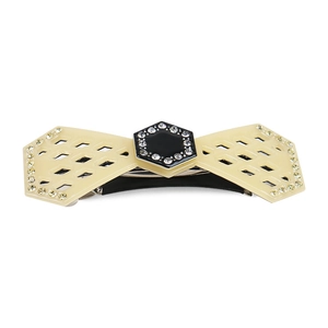 Detail of cream bow hair clip featuring central rhinestone embellishments and a metal spring fastener