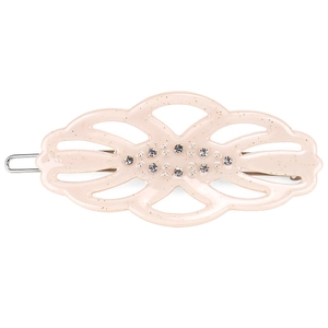 Macro detail of French hair clip with sparkling rhinestones, pearls, and cream acetate texture