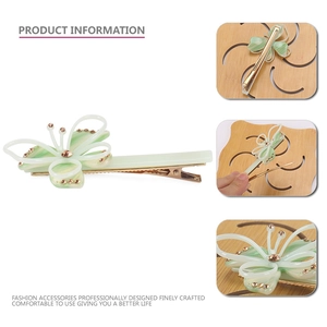 Pince à cheveux papillon en acétate vert clair avec bords dorés et strass élégants