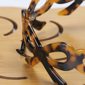 Macro shot of tortoiseshell headband texture with polished resin and hollowed wave design