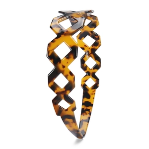 Close-up of tortoise shell pattern headband with geometric diamond cutout details