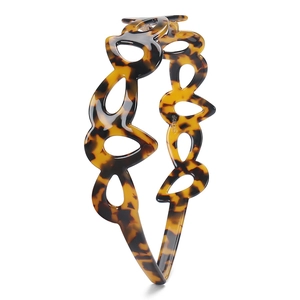 Detailed view of cutout geometric acetate headband with vintage tortoiseshell texture