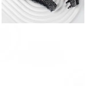 Close-up of elegant black acetate shark hair claw clip with shimmering rhinestones