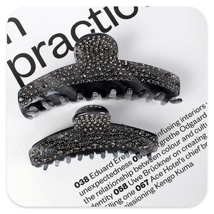 Detailed view of two smoky grey hair claws in small and large sizes with grey rhinestones