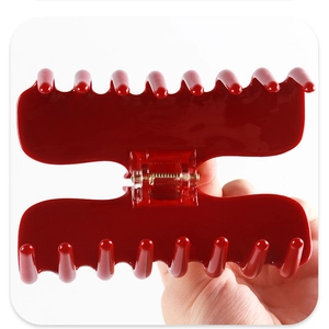 Primer plano de una pinza de pelo roja grande con acabado de acetato brillante de 4 mm