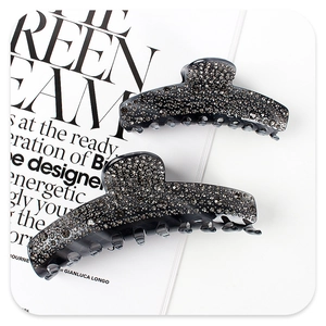 Detailed view of dark grey acetate hair claws with sparkling rhinestones decoration