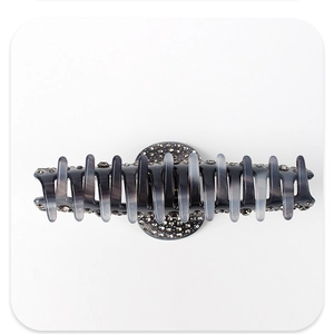 Close-up of smoke gray acetate hair claw clip with sparkling rhinestones and long teeth