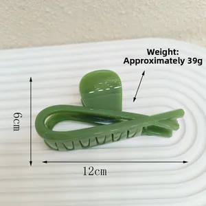 Detail shot showing dimensions of 12cm green hair claw clip on white ripple stand