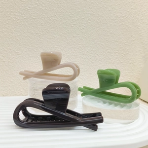 Three oversized 12cm thick PVC hair claws in beige, green, and dark coffee for women