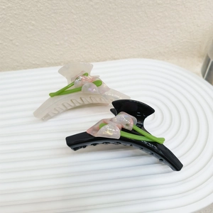 Elegant large tulip hair claw clips in glossy black and translucent cream white