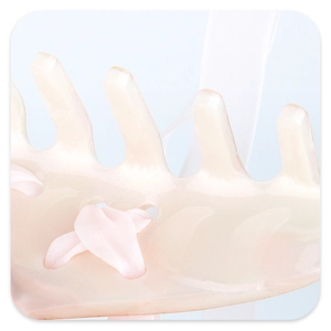 Macro shot of pink translucent acrylic hair claw with a soft white silk ribbon detail