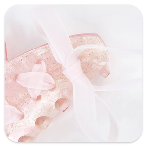 Macro shot of pink marble resin hair claw with glitter and soft silk ribbon bow detail