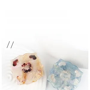 Close-up of Chinese style auspicious cloud and heart splicing hair clips on a white plate
