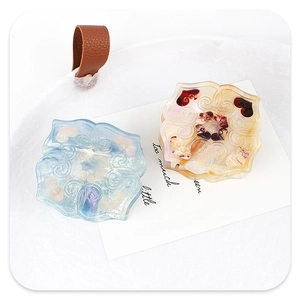 Detail of floral hair claws in ice blue and champagne acetate with heart patterns