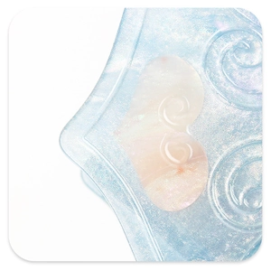 Macro detail of acetate shark hair claw with glitter finish and pearlescent heart inlay