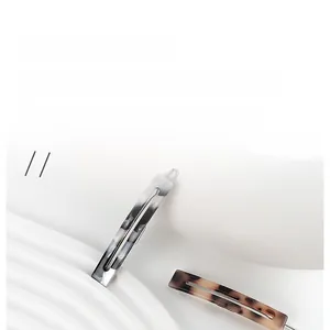 Detail view of French retro acetate hair clips in grey marble and brown tortoiseshell patterns