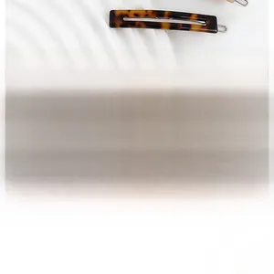 Detail view of rectangular tortoiseshell acetate hair clip with vintage amber texture
