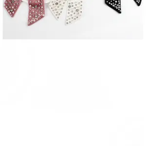 Detail of velvet bow hair clip with faux pearls and sparkling rhinestones for women