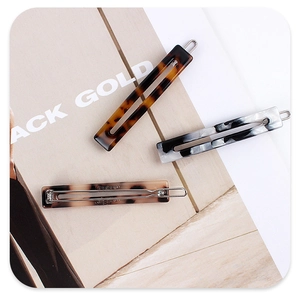 Detailed set of three cellulose acetate rectangular hair clips in marble and tortoise patterns