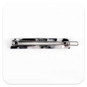 Close-up of black and white marbled acetate barrette with silver metal spring clip