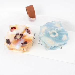 Floral acetic acid shark hair clips with amber and blue marble patterns and relief