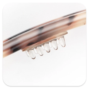Detailed macro view of tortoiseshell acetate hair claw with transparent grip teeth