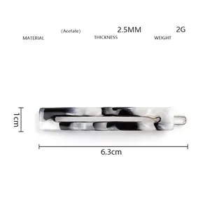 Detail of marble acetate hair clip measuring 6.3cm with lightweight polished texture