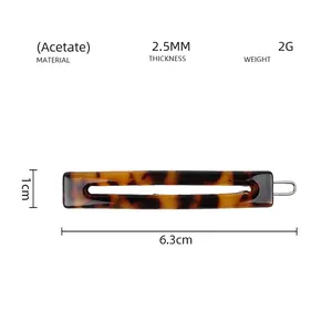 Detail showing the 6.3cm acetate rectangle hair clip with classic tortoiseshell texture