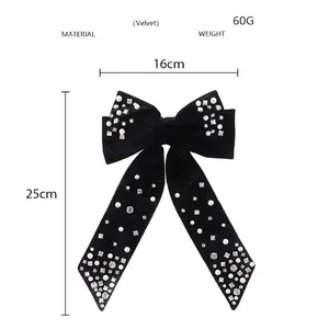 Detail view of velvet bow hair clip with pearls and rhinestones showing 16x25cm size