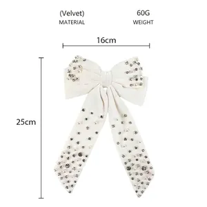 Detailed size view of a large white velvet bow hair clip with pearls and rhinestones