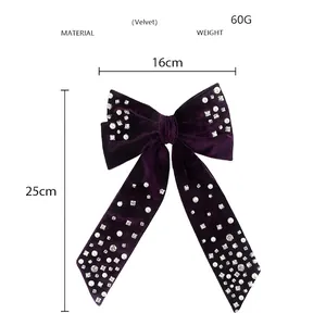 Detail view of purple velvet bow hair clip with pearls and rhinestones 16x25cm