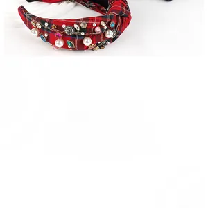 Detailed macro view of plaid fabric headband with pearls and colorful crystal gemstones