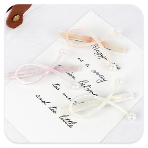 Detailed macro view of acetate infinity hair clips with glitter and pearl accents