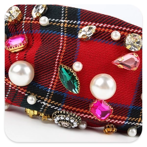 Macro detail of plaid headband featuring baroque style pearls and colorful rhinestones