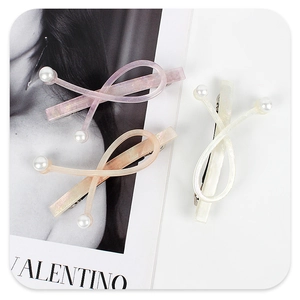 Detailed macro view of colorful acetate hair clips with elegant pearl decorations