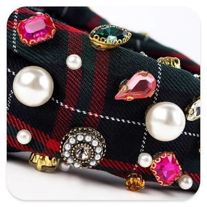 Detail of plaid headband with pearls, pink rhinestones and emerald-colored gemstones