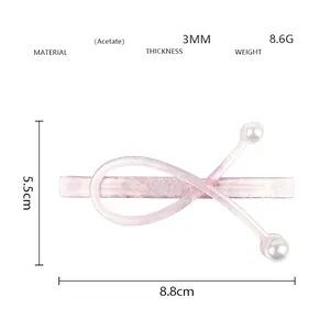 Detailed view of pink glitter acetate hair clip with white pearls and size specifications