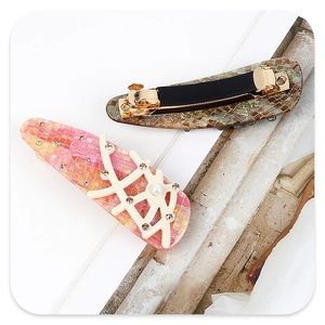 Detail of branch hair clip with coral pattern, acetate texture, and spring clip back