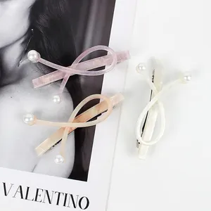 Elegant acetate hair clips with pearl accents in lavender, peach, and white pearlescent finish