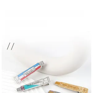 Detailed view of creative toothpaste-shaped acetate hair clips with metal duckbill base